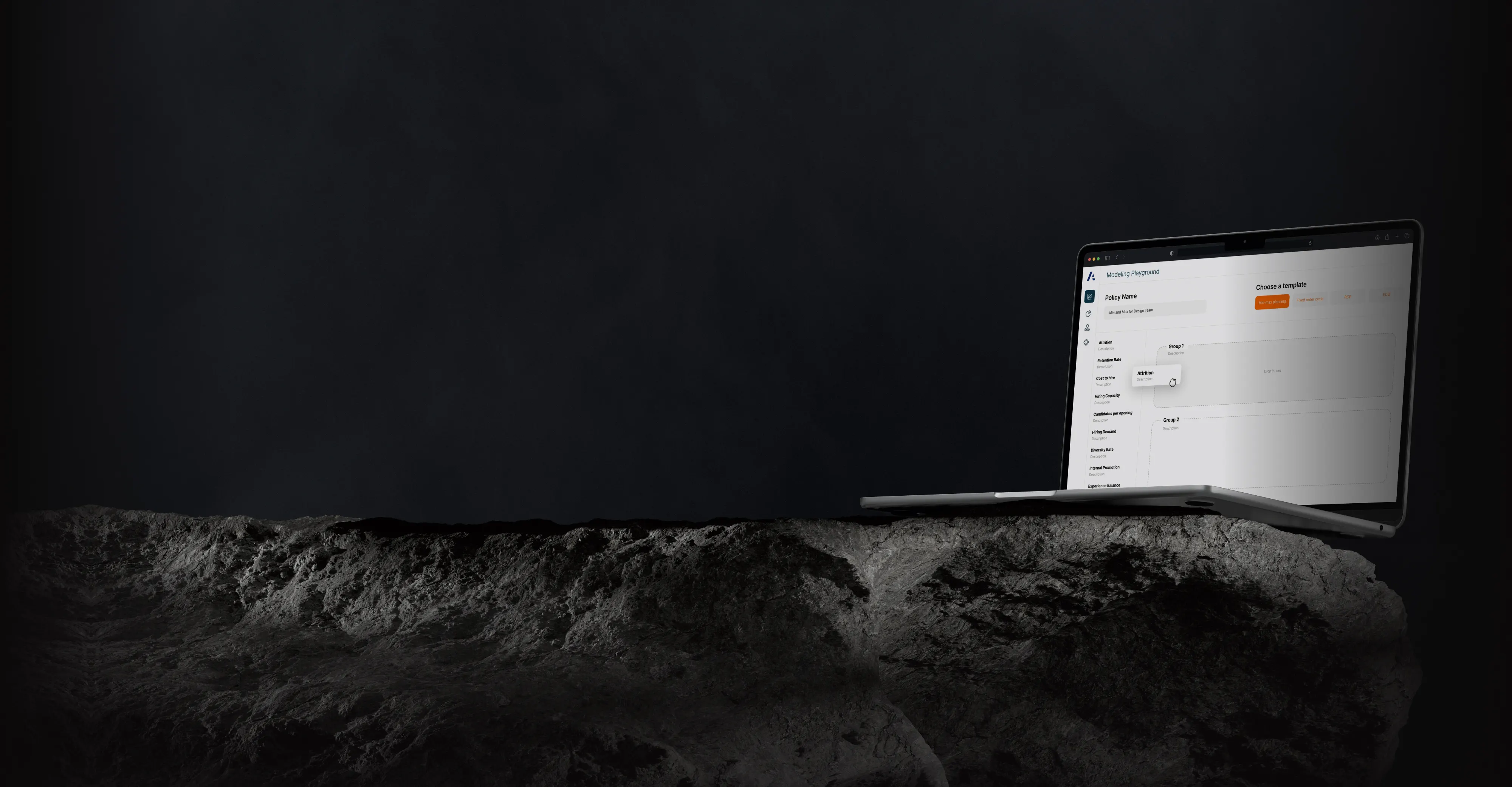 Laptop on a rough stone slab, showing the Anaplan modelling workspace